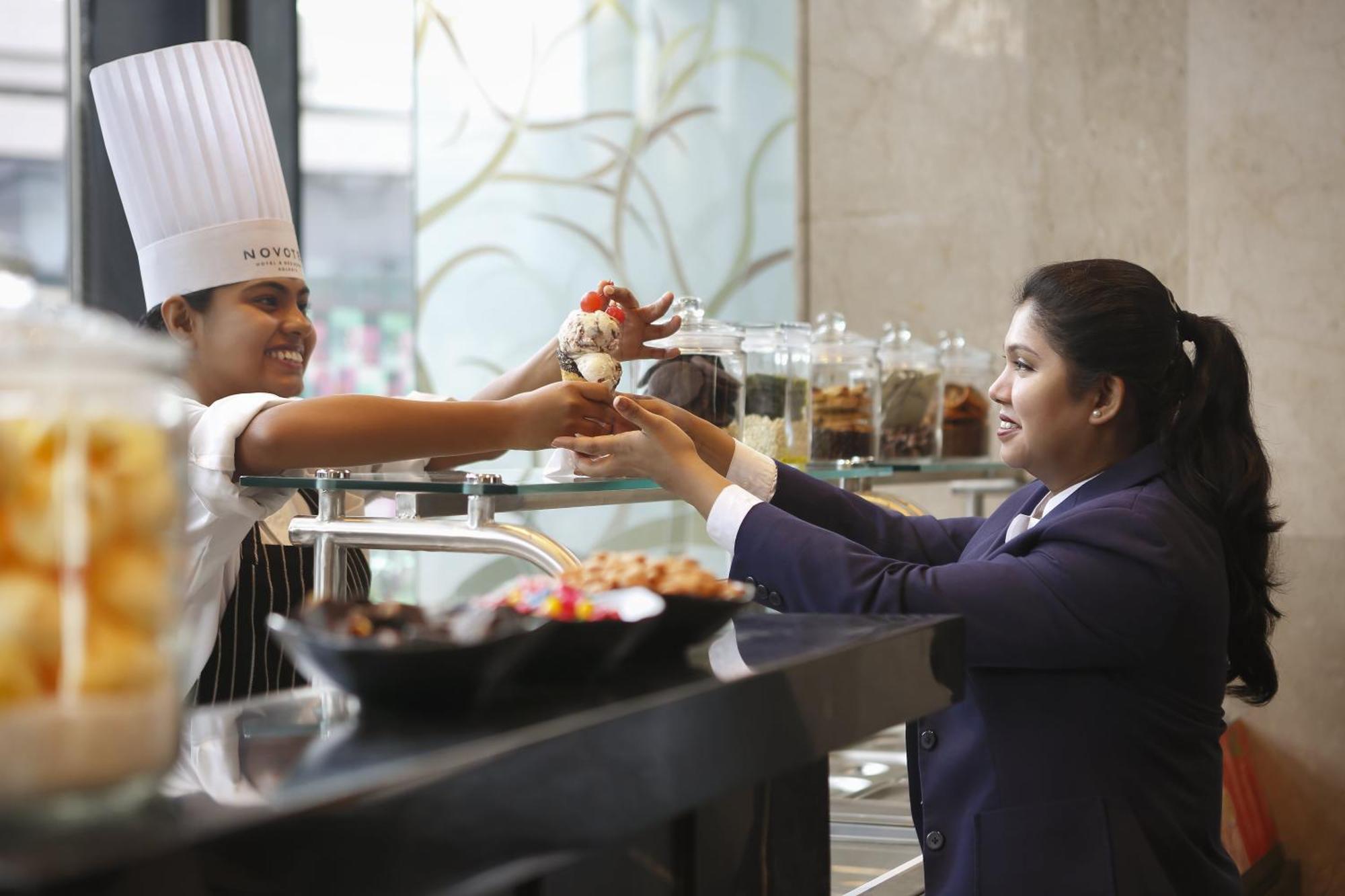 Novotel Kolkata Hotel And Residences Exterior photo A chef serving food to a guest